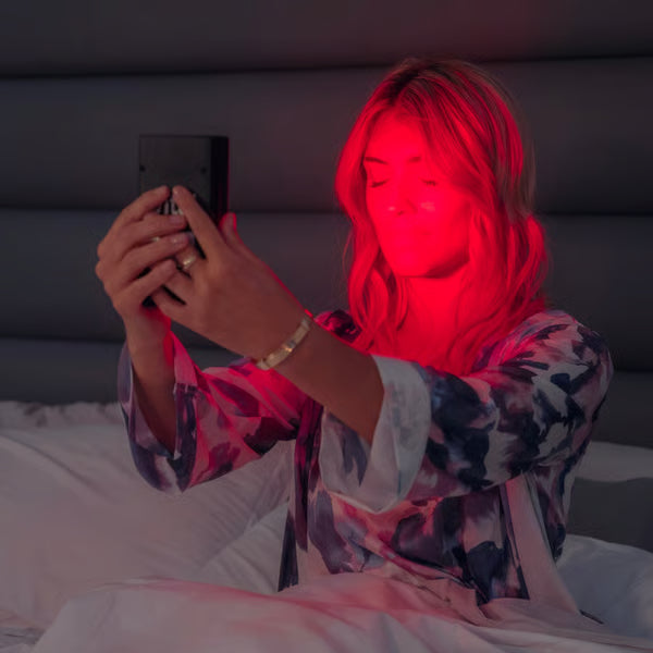 A woman using her Vital Charge red light therapy device to sleep better and treat chronic pain|post surgery recovery|How red light improves post surgery recovery