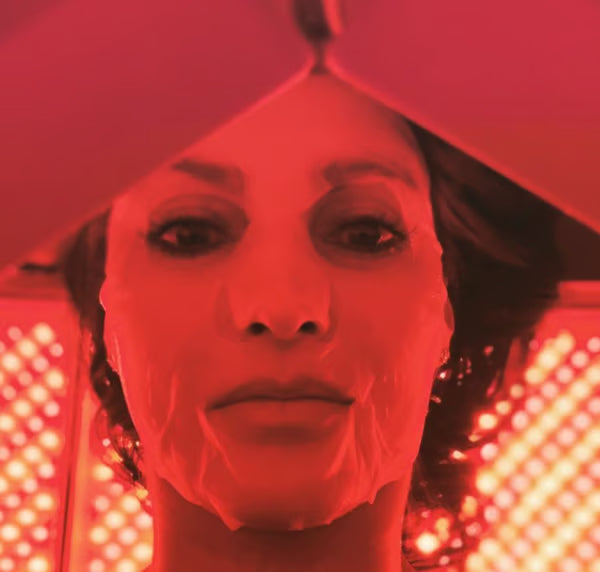 A woman using Vital Red Light devices and a cleansing face mask for skin health|Tips for Healthy Glowing Skin