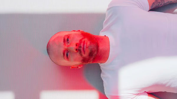 Guy with red light therapy