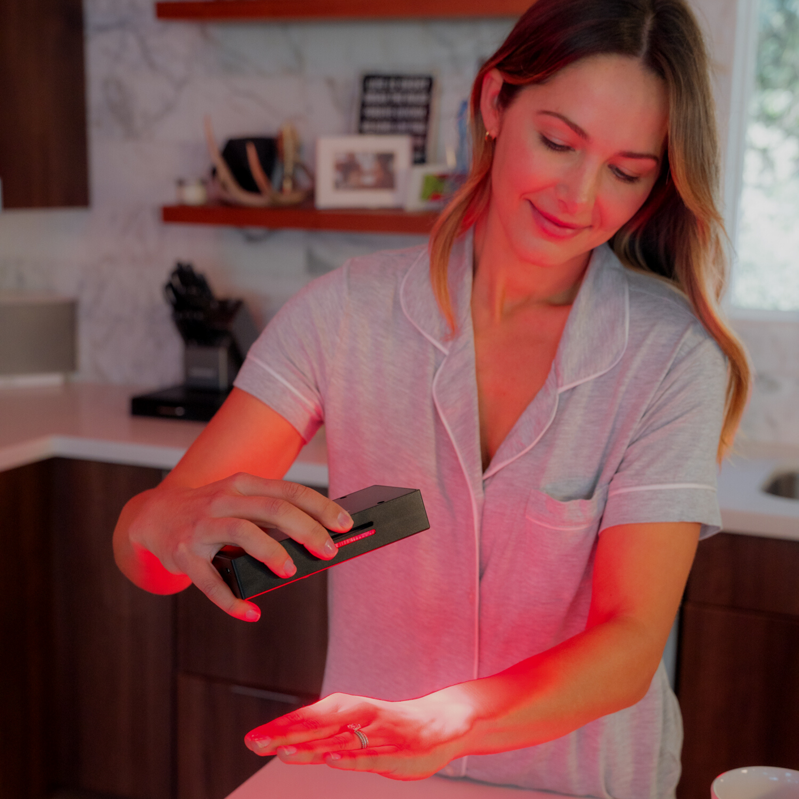 woman using handheld light therpay for pain