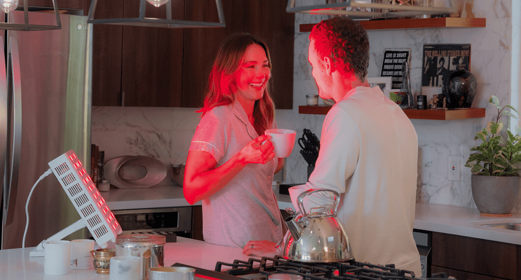 Couple using red light therapy with coffee